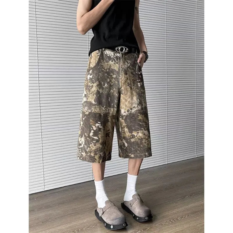 Yellow cotton denim jeans with snake camouflage pattern and cropped leg length.