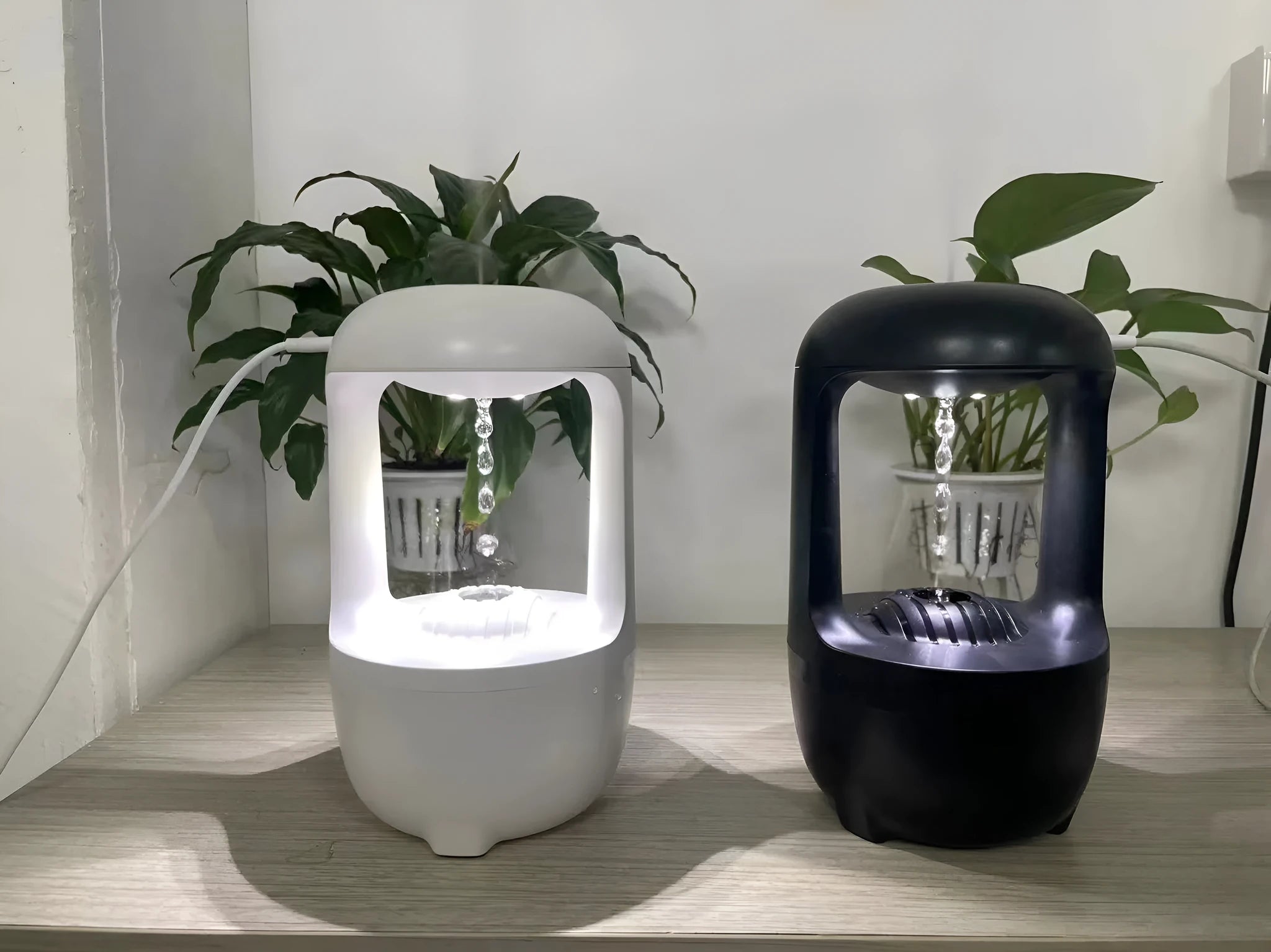Black and white anti-gravity humidifier showing water droplet effect with USB cable