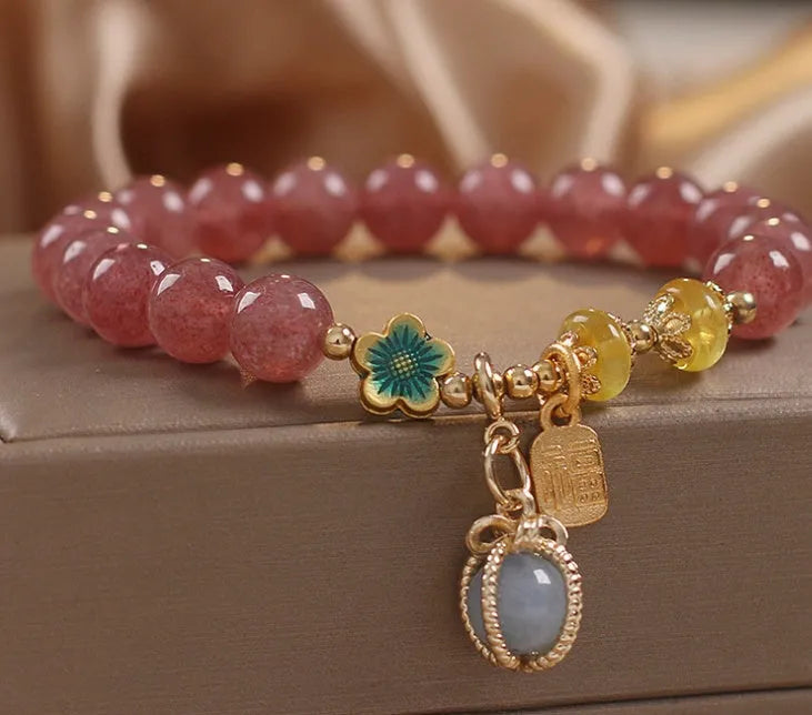 Red strawberry quartz beaded bracelet with metal alloy setting and sparkling rhinestone details.