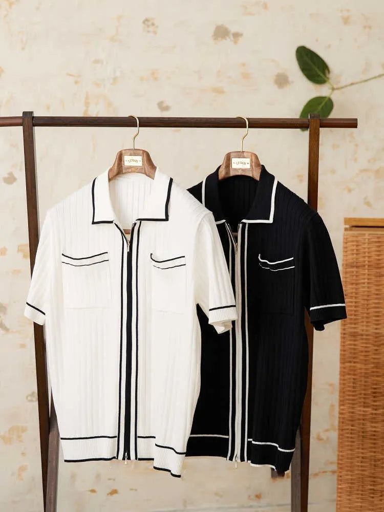 A black slim fit polo shirt with a lapel collar and short sleeves on a hanger.