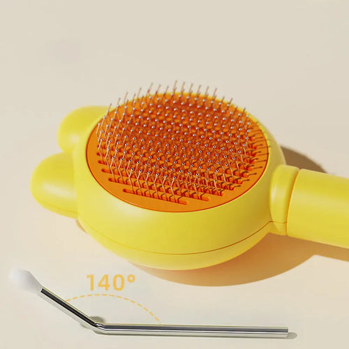 Green pet grooming brush with a self-cleaning button and a stainless steel comb.
