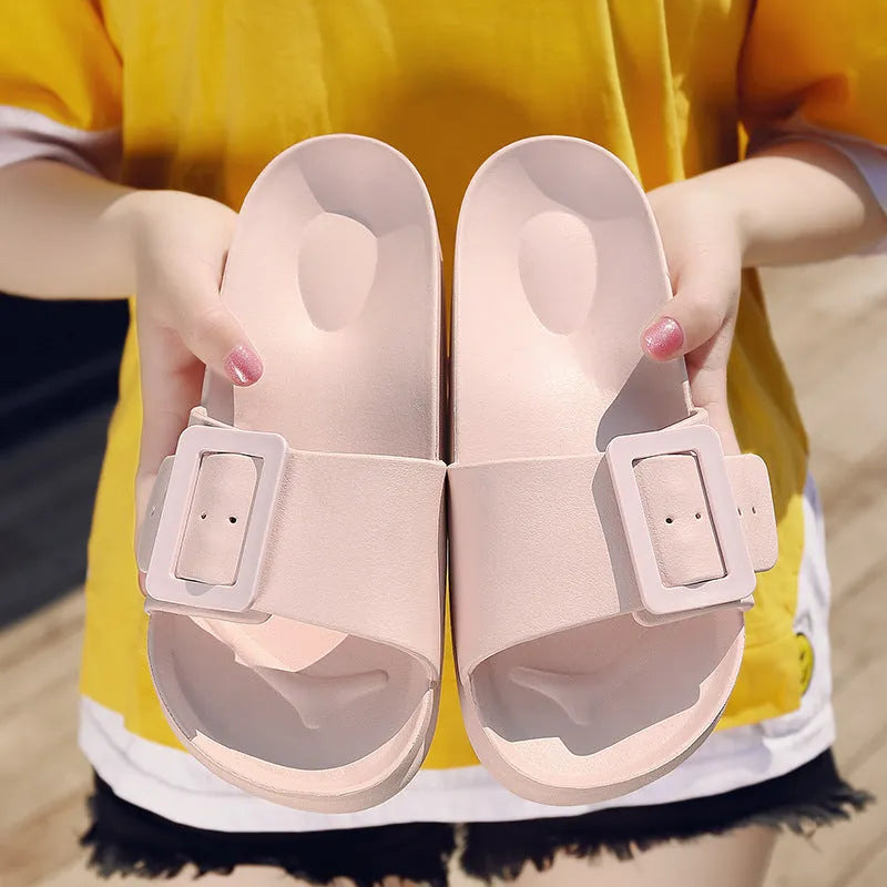 Women's grey blue EVA foam slippers with a buckle strap and soft sole.