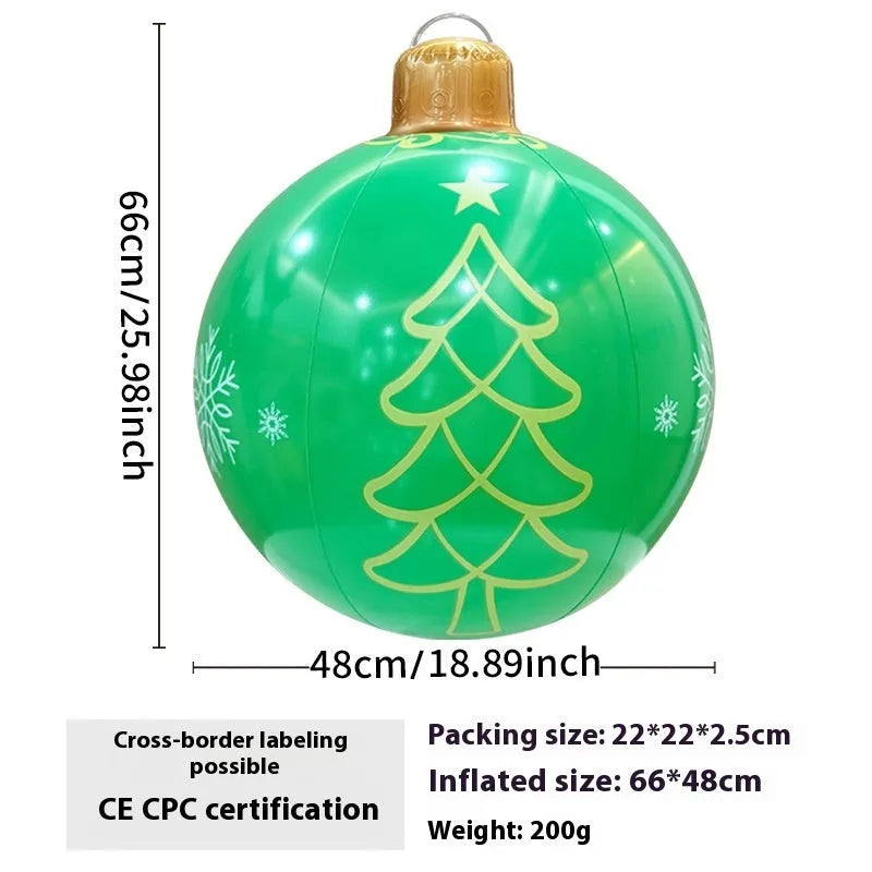 Large red and white inflatable Christmas ball with flashing lights standing in a garden.