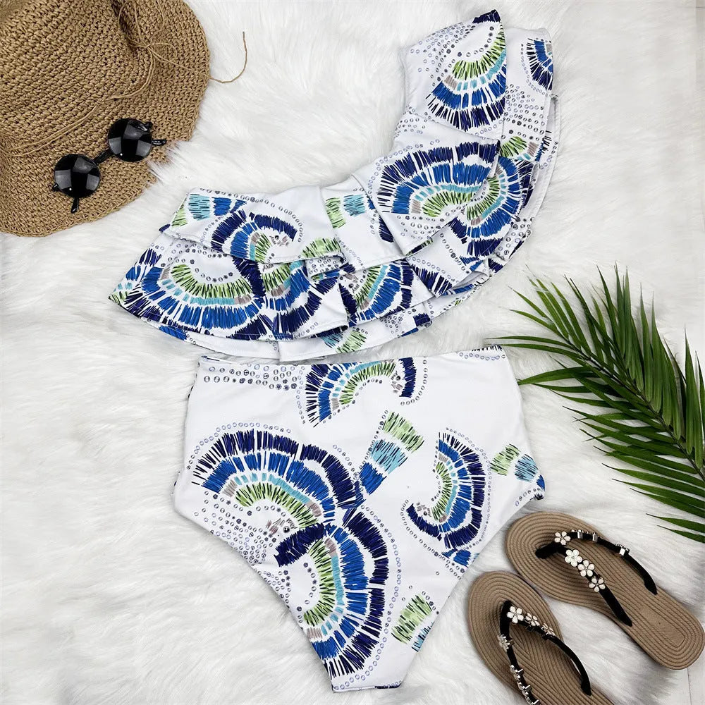 White women's one-shoulder bikini with a large lotus leaf design and split front.