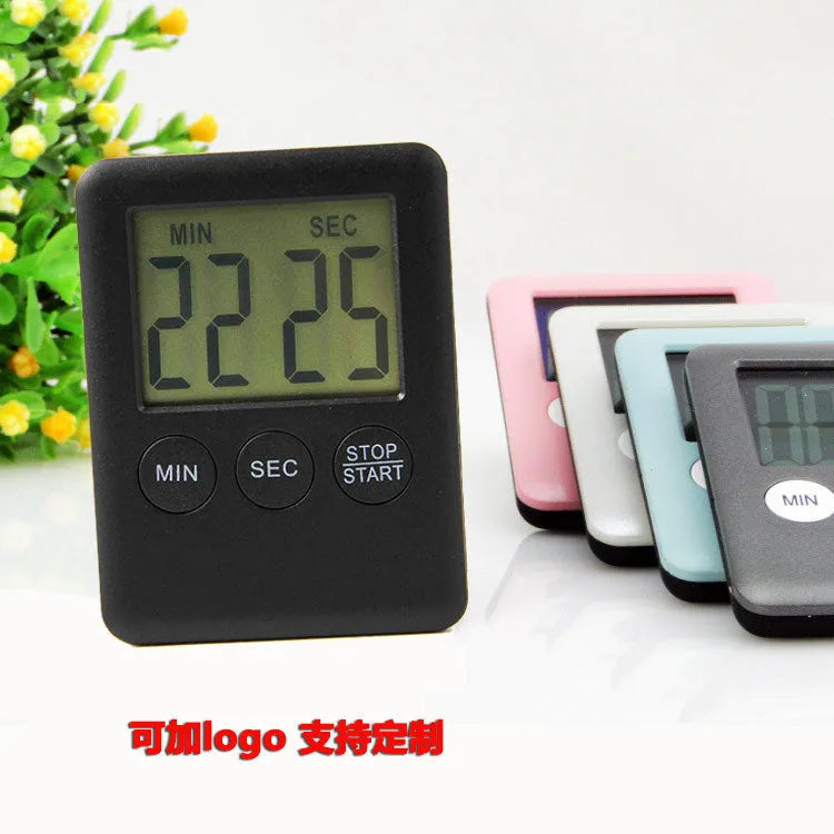 Black and white kitchen timer with magnetic backing showing count-up and countdown display