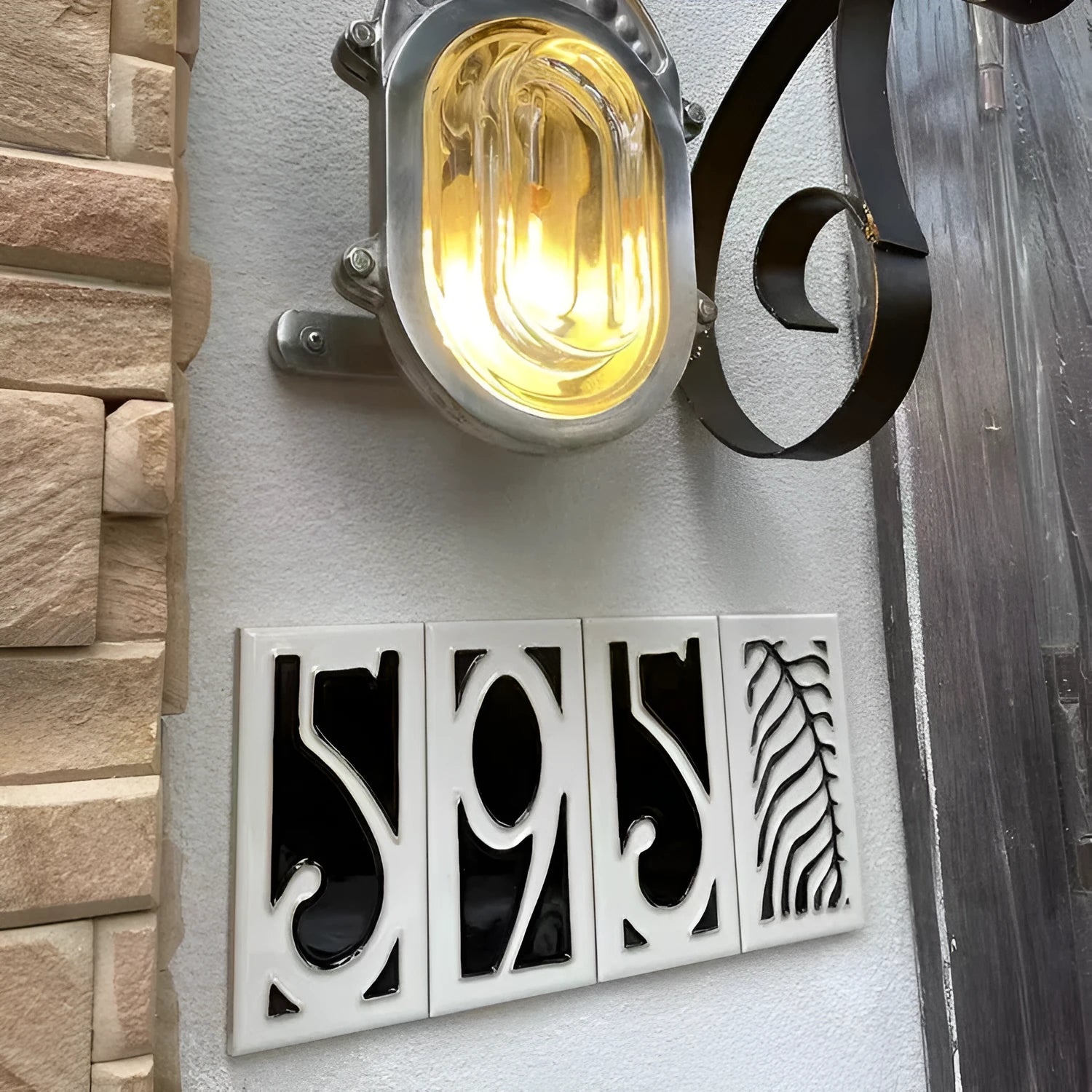 Handmade retro-style ceramic doorplate with large white enamel number 5 on a black background, showing scale.