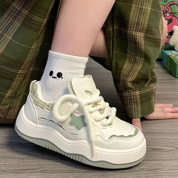 Women's green patent leather platform sneakers with round toe and lace-up closure