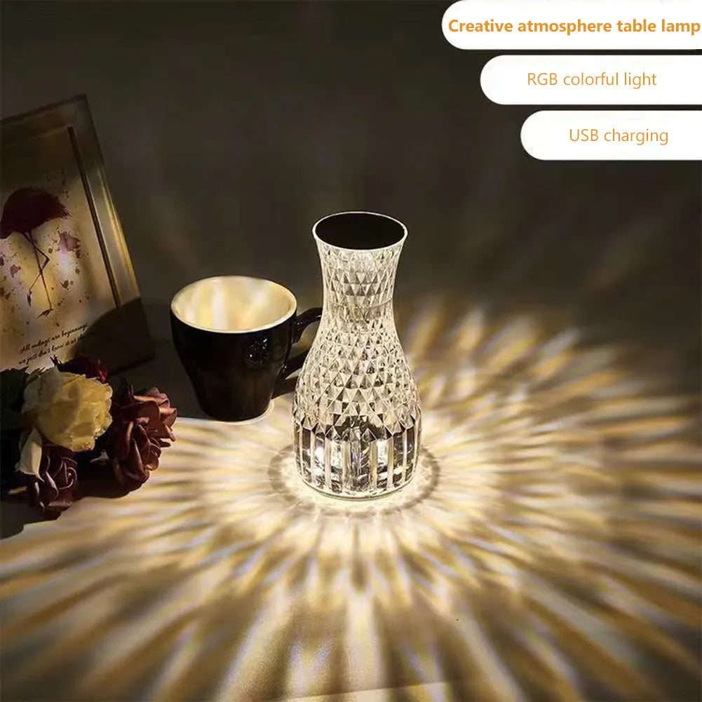 Vase-shaped crystal table lamp with LED lights and remote control on a bedside table