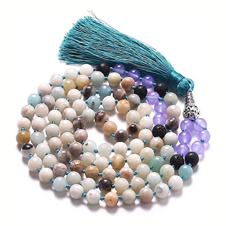 Long agate and amethyst gemstone tassel necklace with geometric pendant on a model.