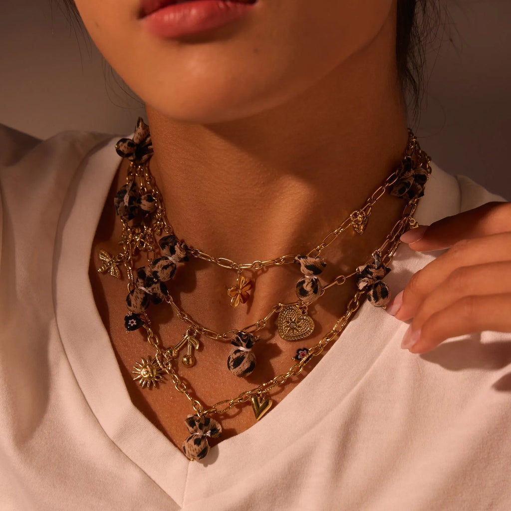 Stainless steel necklace with a geometric leopard and love heart flower pendant on an adjustable chain.