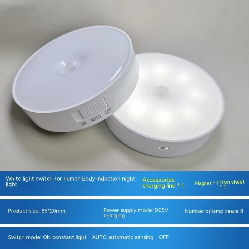 Small white circular motion sensing LED night light with USB charging cable and adhesive tape.