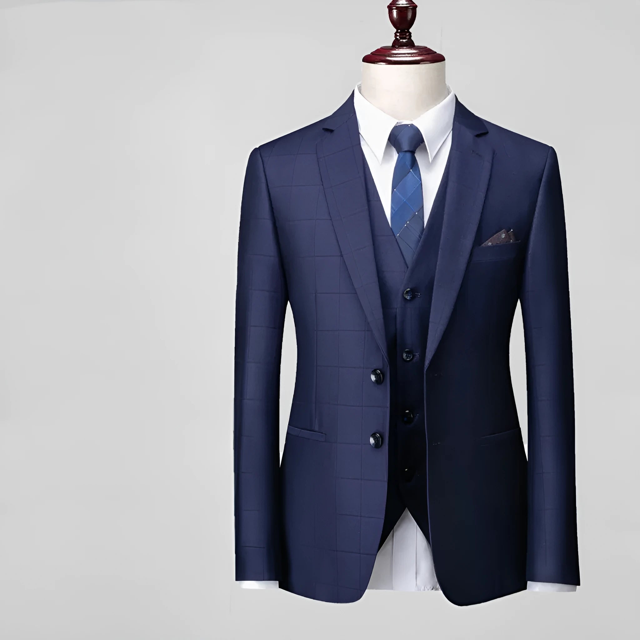 Men's navy blue plaid slim fit three-piece business casual suit on a hanger.