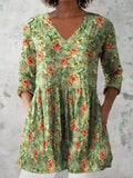 Women's printed wave-pattern loose dress with wide waist and three-quarter sleeves on a mannequin.