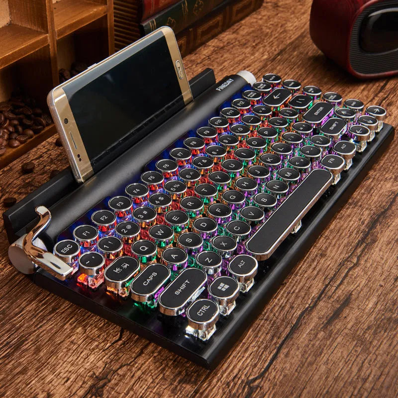 Black retro typewriter mechanical keyboard with backlit keys on a desk