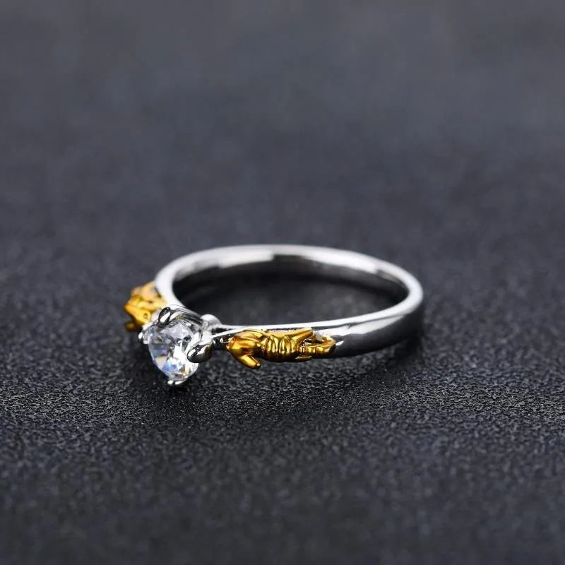 Detailed black gold copper crown ring on a finger, showing crown modelling and metallic finish.
