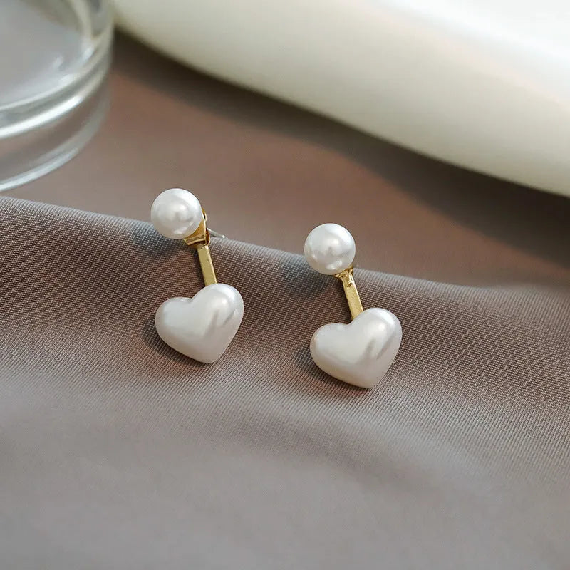 Heart-shaped alloy stud earrings with electroplated finish and inlaid artificial stones.