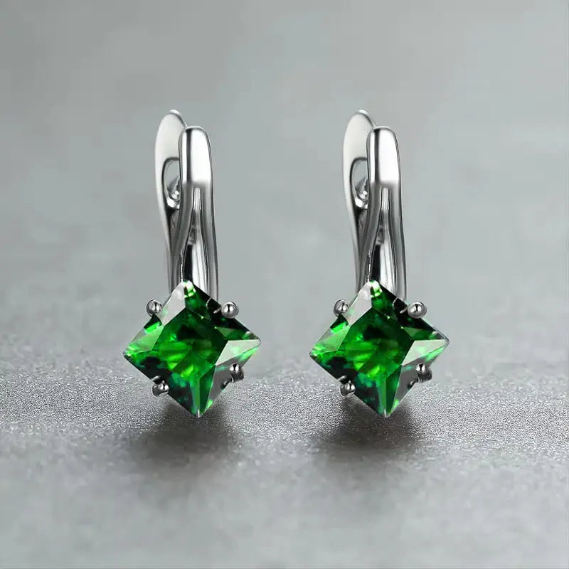 Women's copper earrings with diamond design and inlaid blue zircon stone.