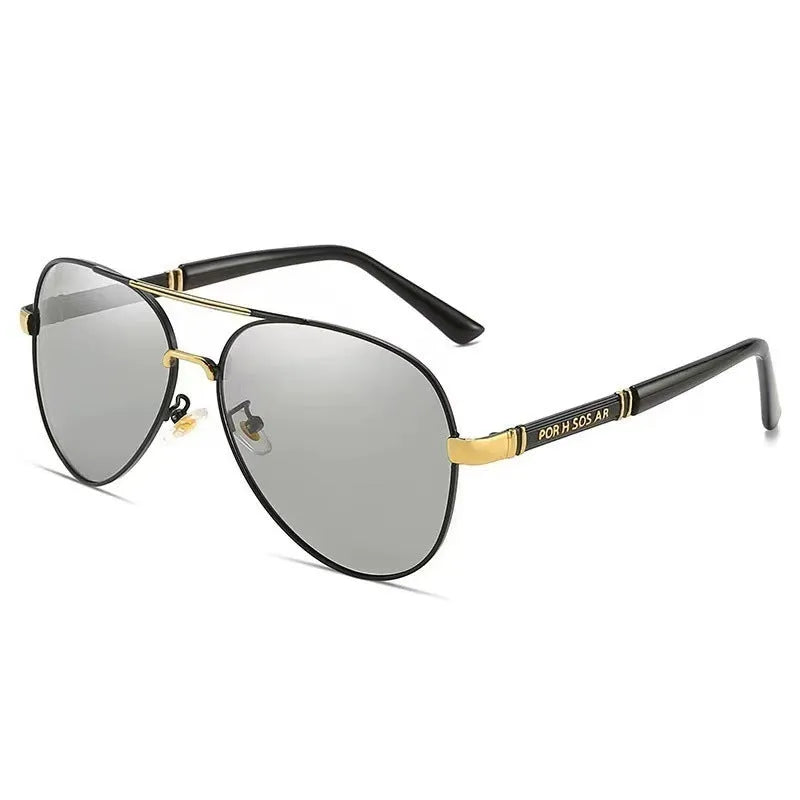 Gold frame men's polarised sunglasses with dragon-phoenix temple detail and grey lenses on a table.