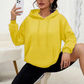 Women's loose grey drawstring pocket sweatshirt with long sleeves on a hanger.
