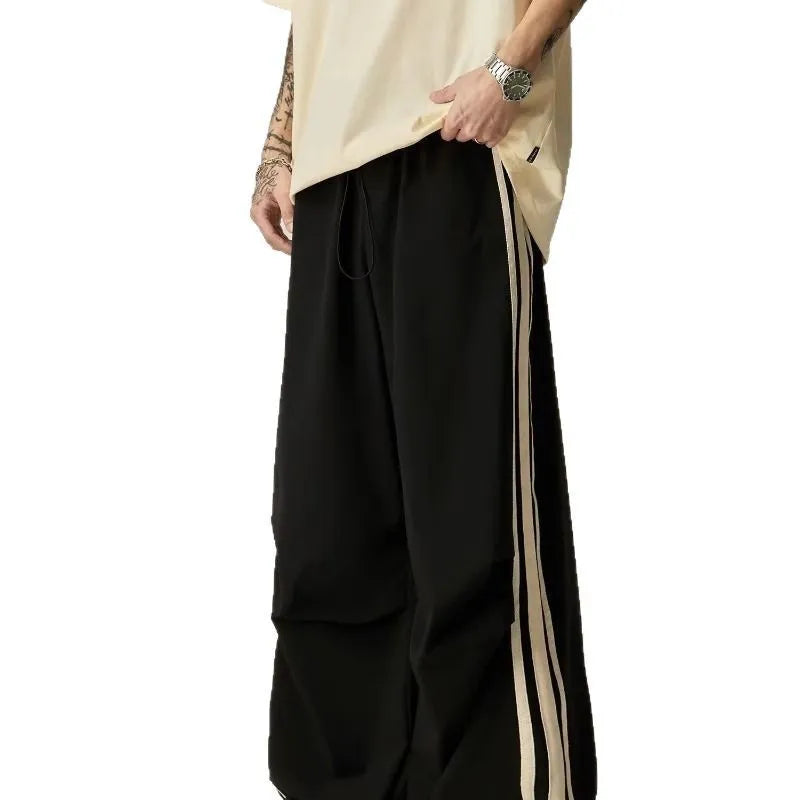 Black high-waist wide-leg climbing trousers for men laid flat, showing straight-leg style.