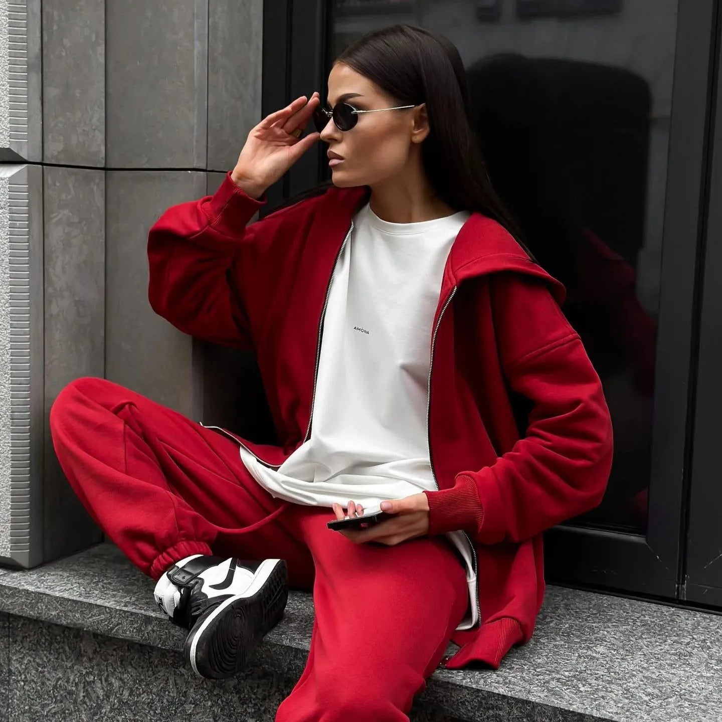 Red loose-fit street style two-piece set with long-sleeved coat and trousers on a model.