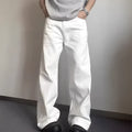A man wearing white loose straight-leg cotton jeans with a mid-waist and zipper fly.
