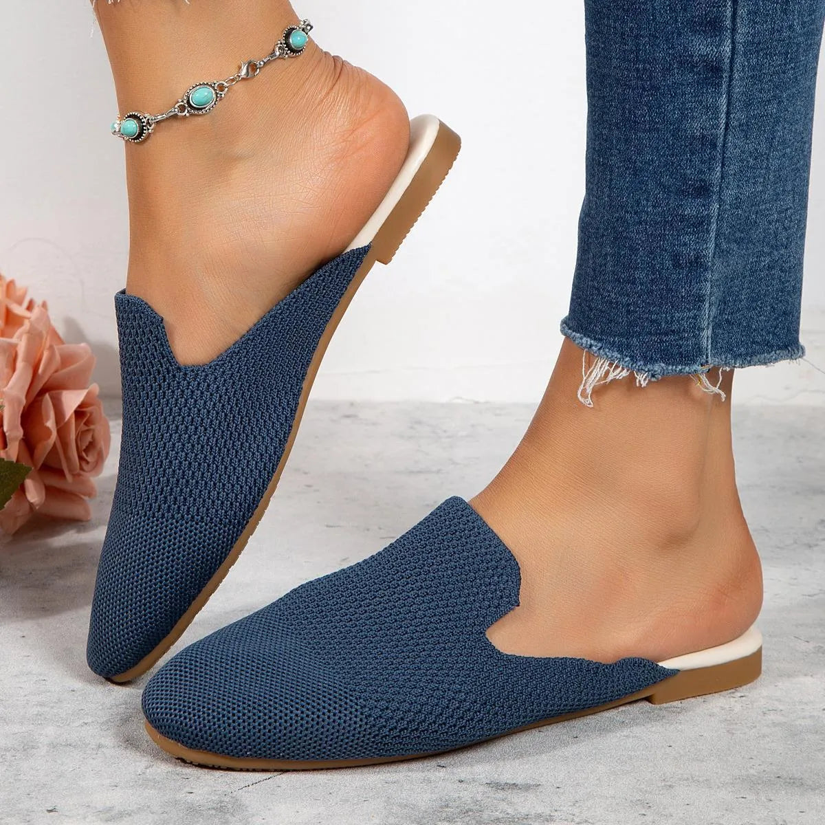 Apricot coloured mesh slip-on sandals with round toe and flat rubber sole on a white background.