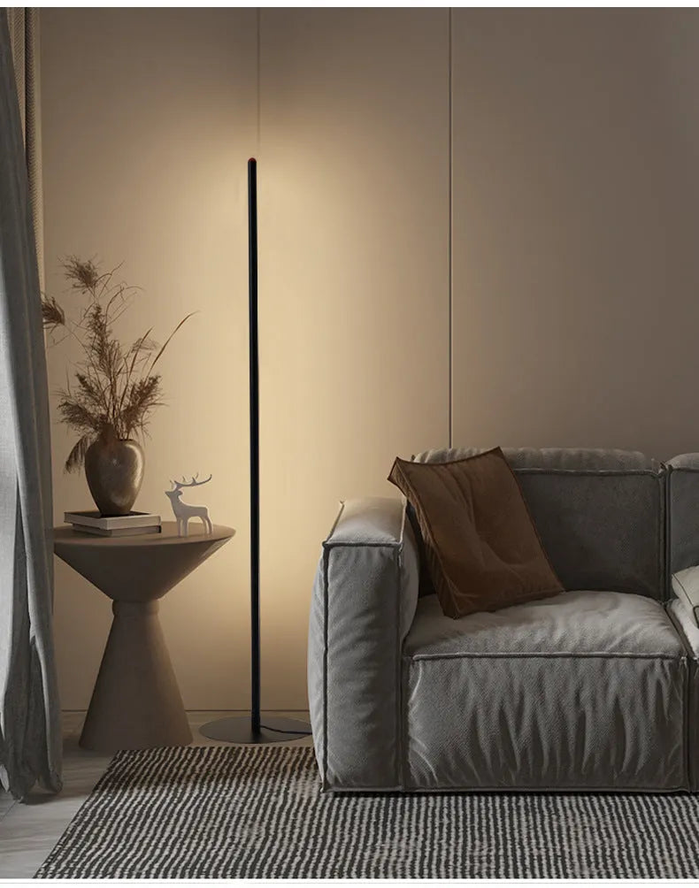 Simple modern vertical aluminium alloy floor lamp with LED light in a living room corner.