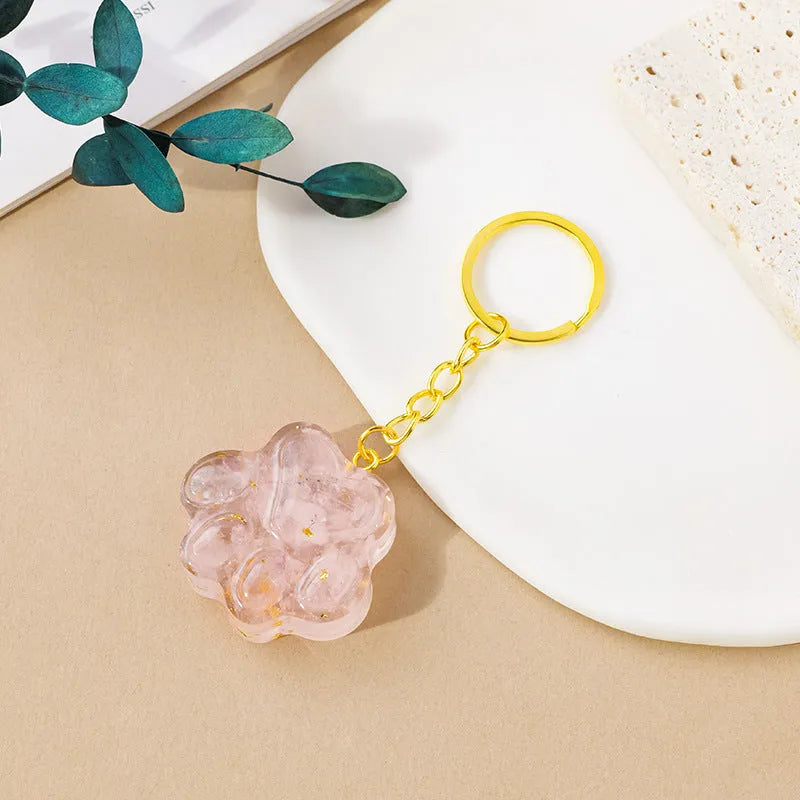 Small natural crystal cat's paw pendant on a metal keyring, available in various stone colours.