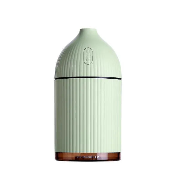 White USB aromatherapy diffuser and humidifier with LED light on a wooden desk