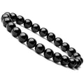 Close-up of a women's black agate bracelet with 8mm geometric beads on a black elastic cord.