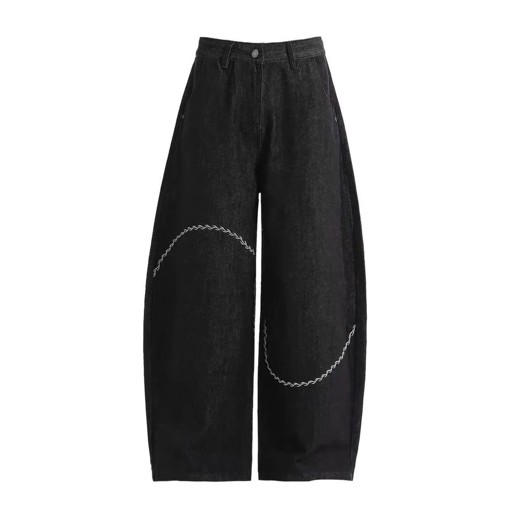 Black straight-leg denim trousers with a mid-waist fit and micro-elastic waistband on a hanger.