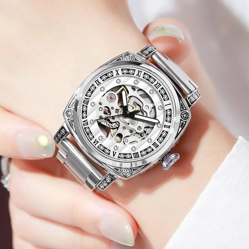 Mechanical analogue watch with luminous hands and a leather strap, shown in multiple colour options.