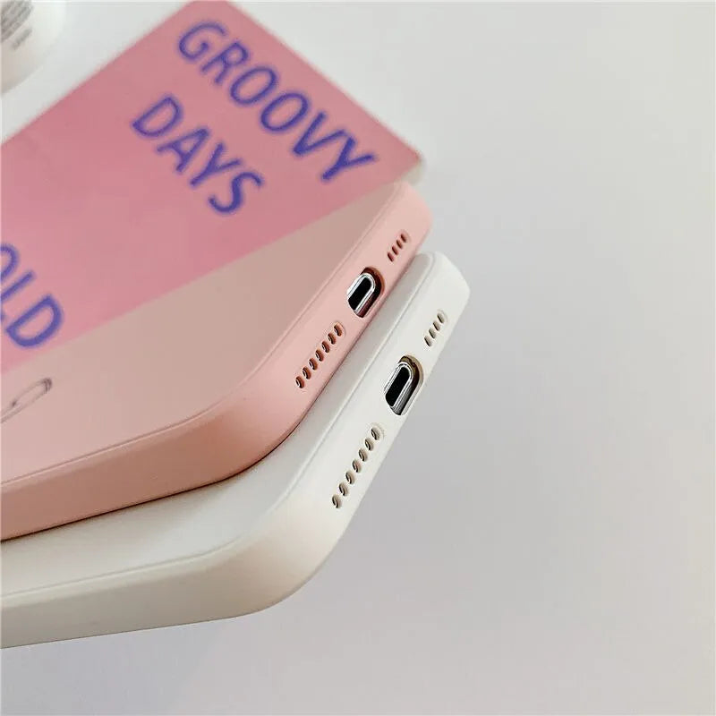 A solid colour silicone phone case for Apple iPhone on a table, showing its slim TPU back cover design.