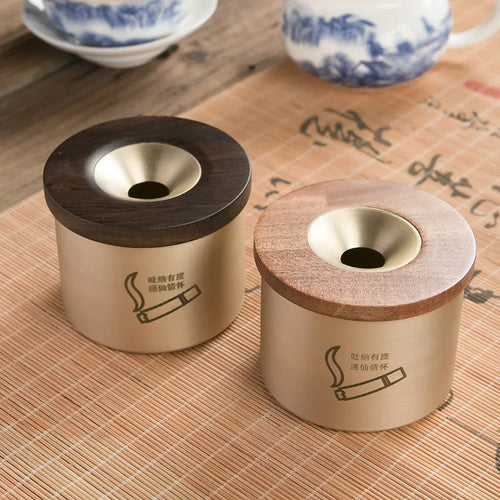 Retro brass ashtray with wooden lid showing centre hole design for ash collection