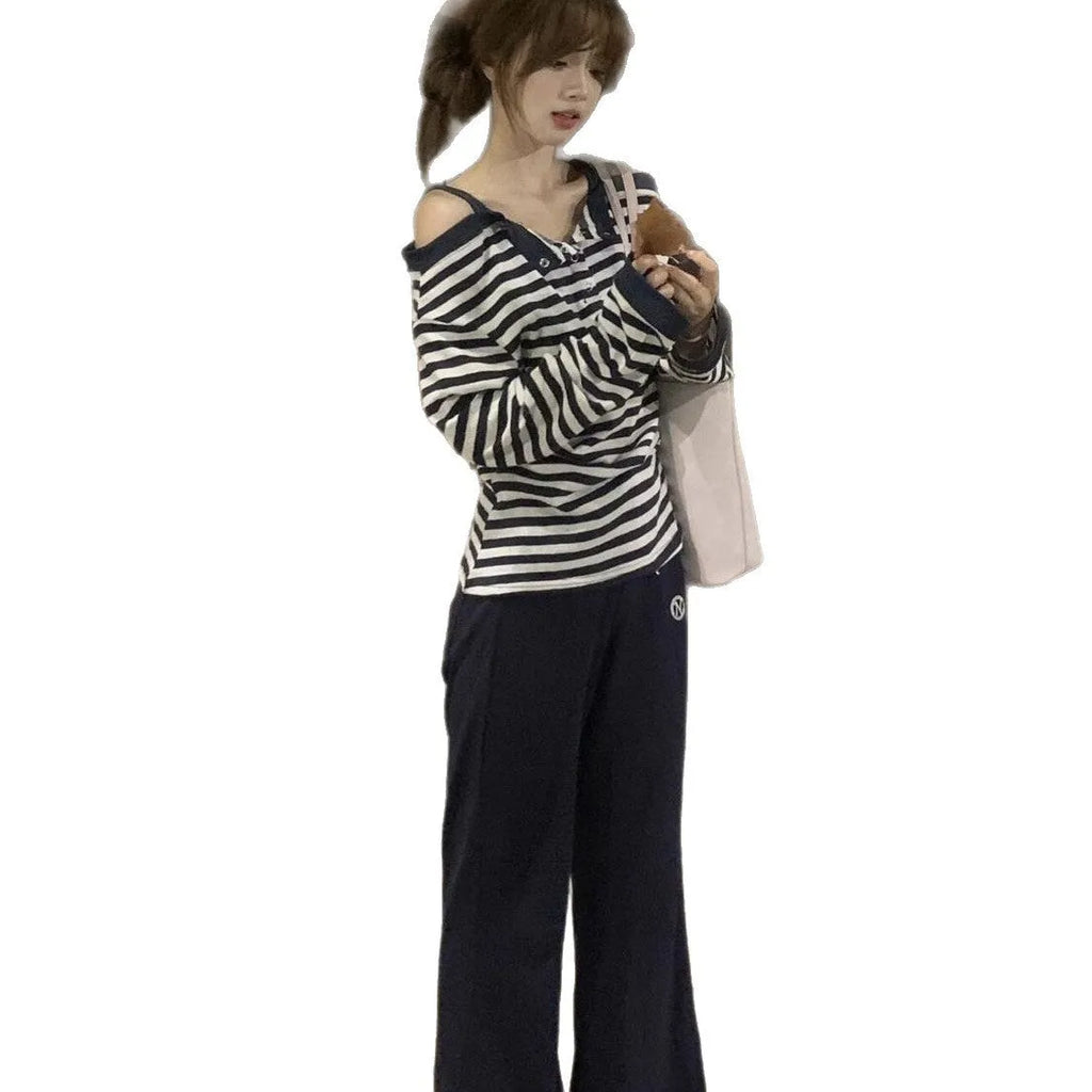 Dark blue oversized long-sleeved women's T-shirt with stripes and embroidery details.