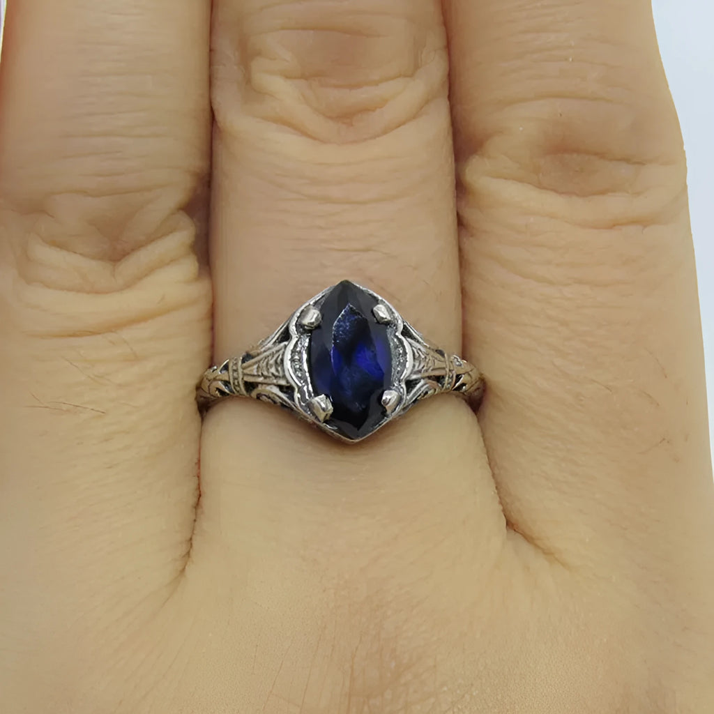 Silver women's geometric hollow alloy ring showing detailed openwork design.