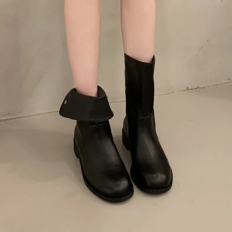 Women's black leather mid-calf platform boots with silver stud details on a white background