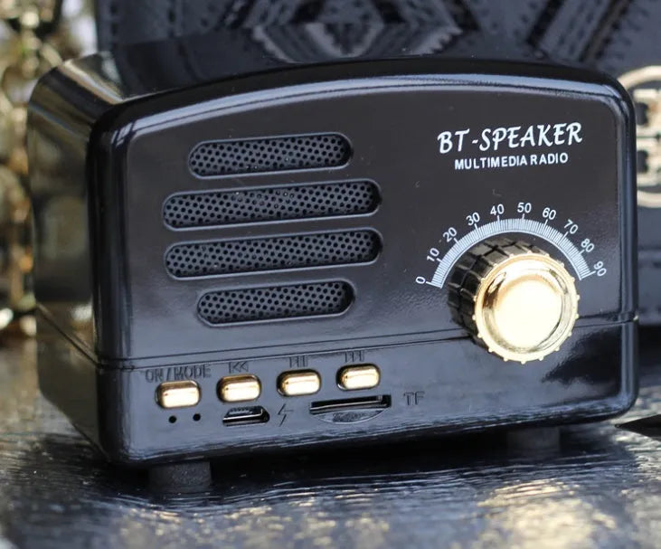 Compact vintage wood-grain finish Bluetooth speaker with control buttons on top.