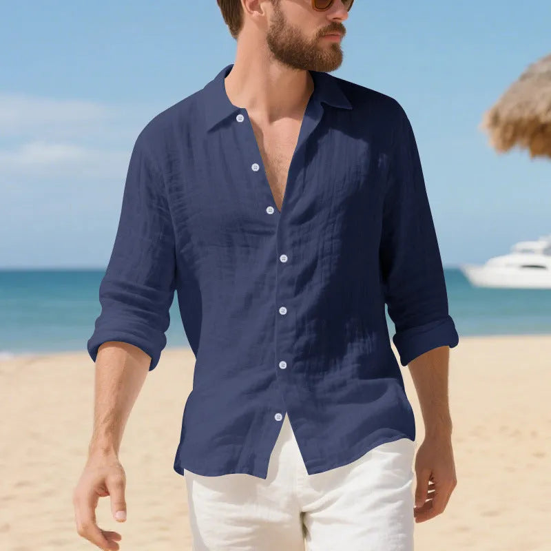 A man wearing a loose-fit light blue linen casual shirt with a non-iron finish, buttoned front and standard collar.