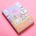 Small white notebook with magnetic buckle showing Kaba Bear Hippo design on PU leather cover