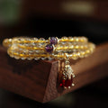 Natural Brazil gold rutilated quartz bracelet with three circular accents and Chinese-style hanging chopsticks design
