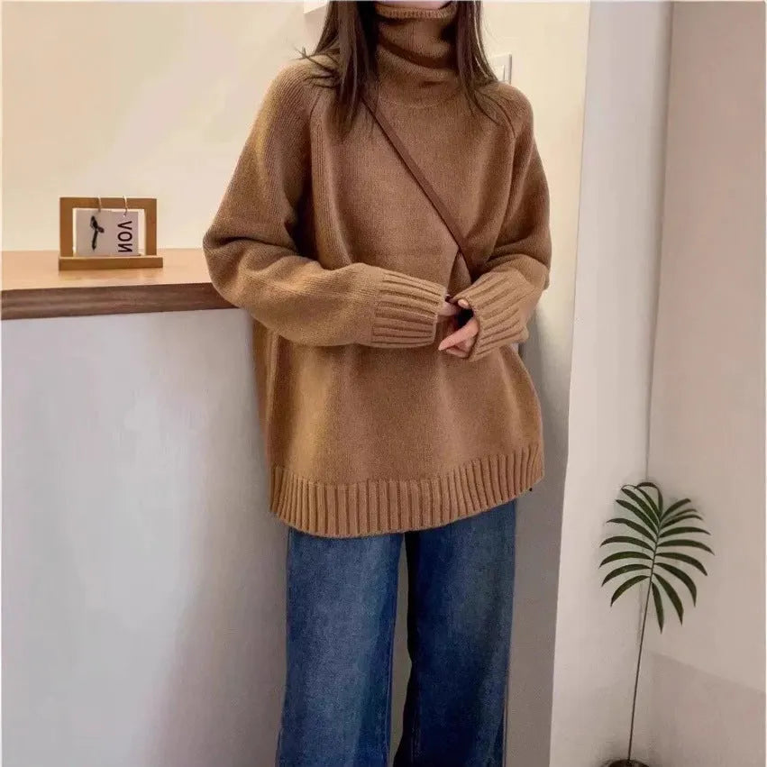 Women's thick grey turtleneck sweater with a textured curling pile collar, loose casual fit.