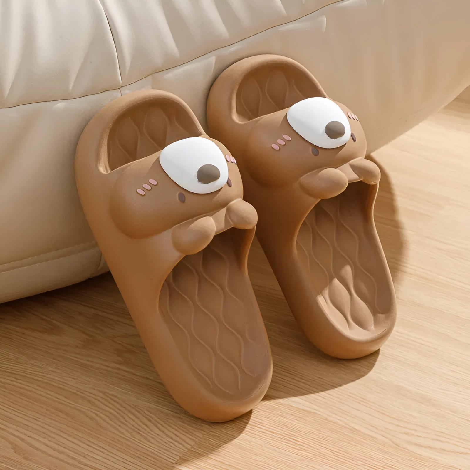 Pair of brown cartoon bear EVA flip flops for adults, toe baring sandal style