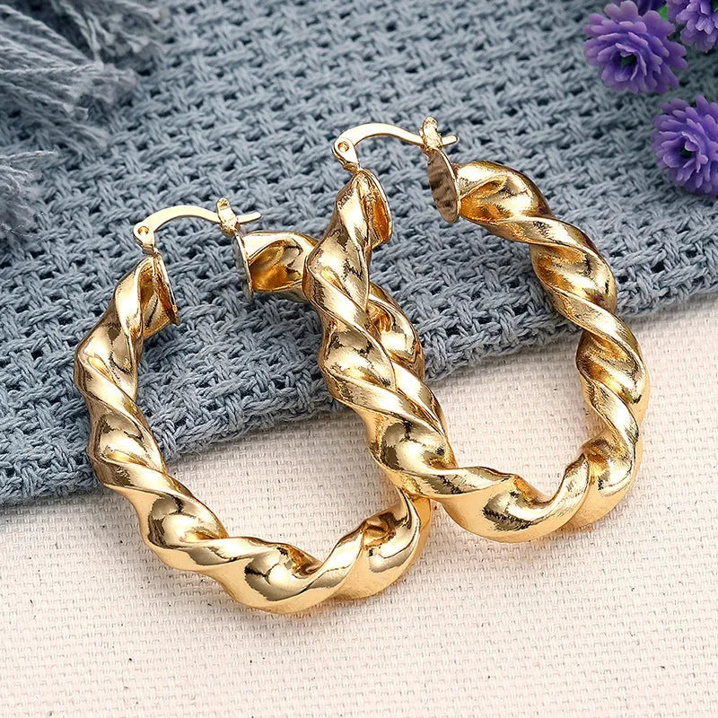A pair of geometric design clip-on earrings for women with a drop shape and ring-and-line details.