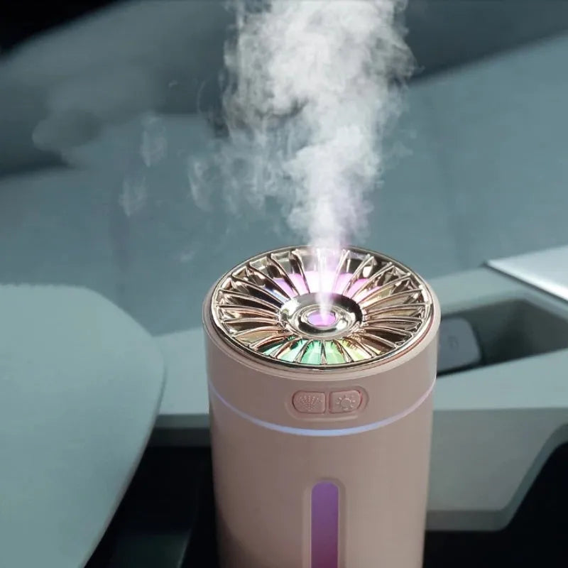 Black portable USB rechargeable humidifier with colourful lights on a car cup holder.