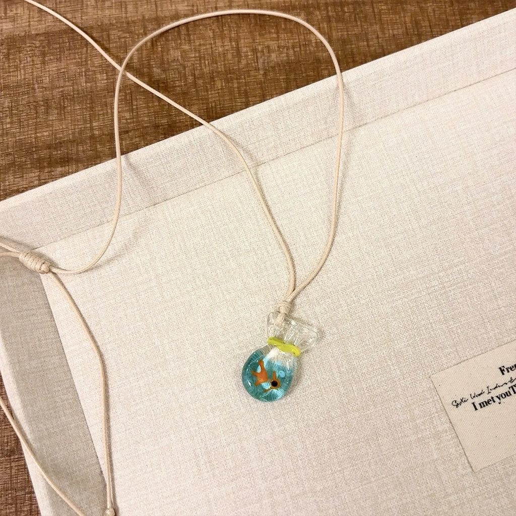 Women's joker pendant necklace on braided cotton linen cord with adjustable lobster clasp.