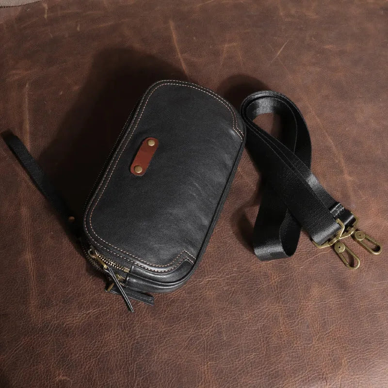Men's small phantom black cowhide crossbody bag with pillow shape and zipper pockets