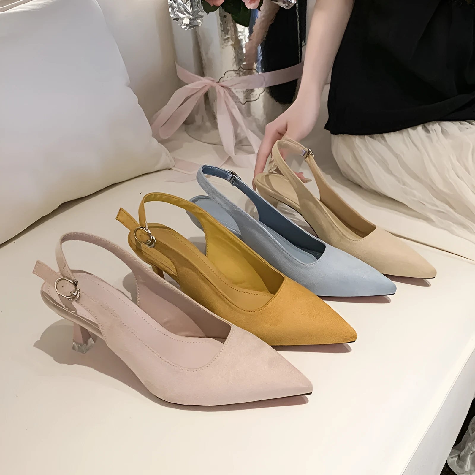 Women's suede pointed-toe stiletto high heels in apricot, pink, sky blue, and yellow colours on a rubber sole.