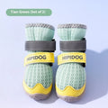 Pair of light blue cartoon-style dog shoes with adjustable strap, shown on a dog's paw.